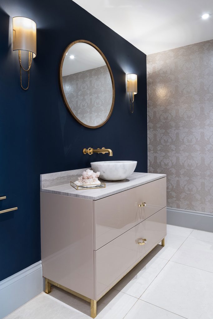 A bespoke bathroom vanity unit in a lacquer finish with a quartz countertop and surface mounted sink. Made by Origins Design for a private home in Cobham, Surrey