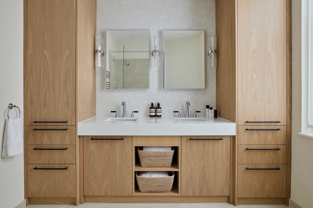 A fully fitted bespoke bathroon vanity unit with double sinks, ample storage and recessed sinks. Made by Origins Design for Interior Design Karen Oliver